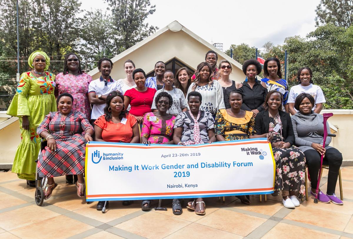 Group photo of the participants to the MIW third Gender and Disbality, front row participants are holding a banner of the event